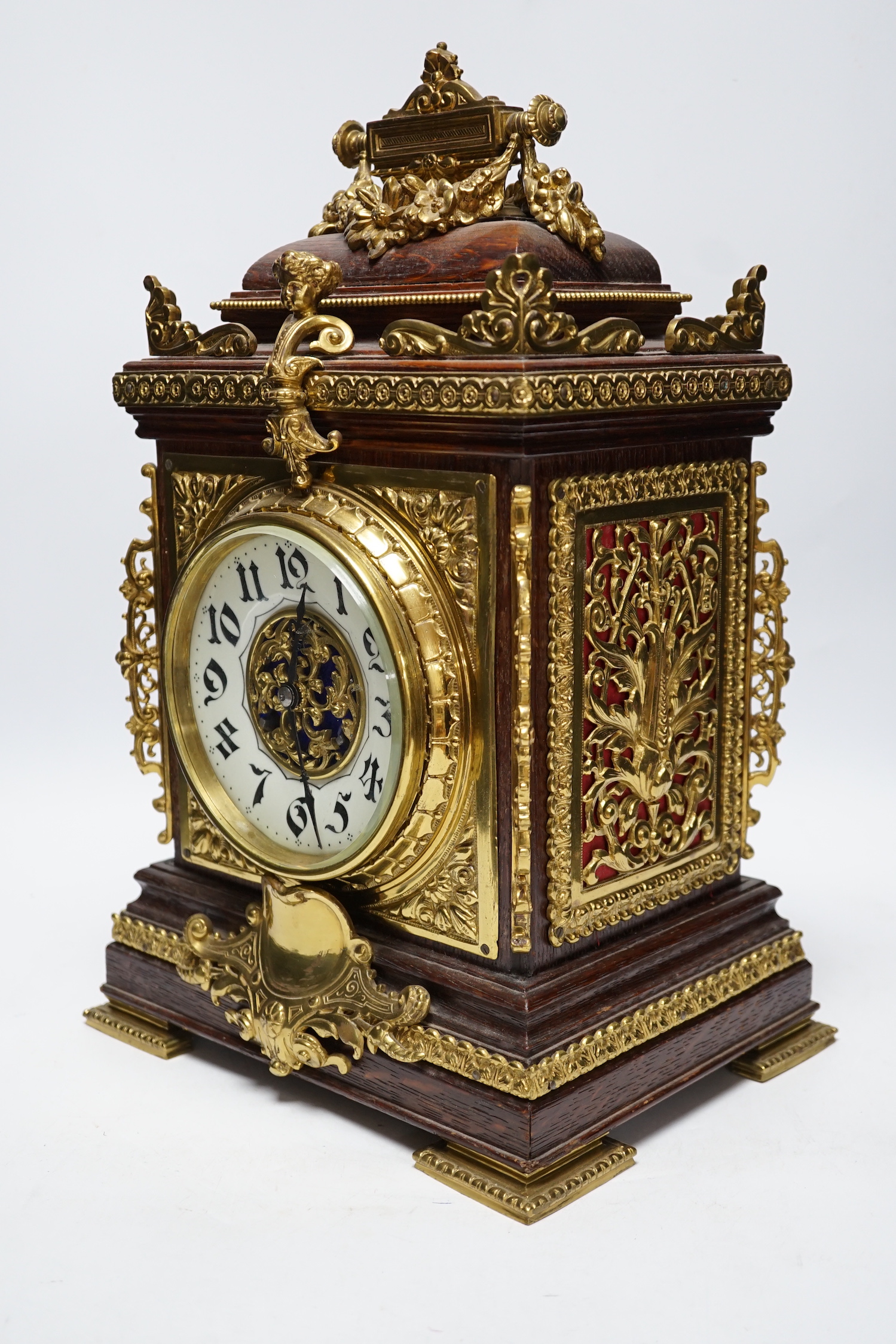 A French oak and brass mounted mantel clock with enamel dial, 42cm high
